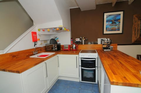 Well equipped fitted kitchen with cooker, kettle, toaster and microwave