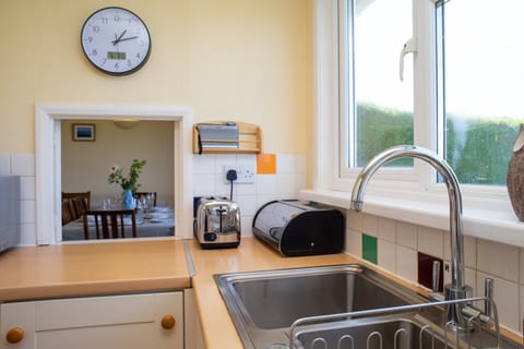 Kitchen with toaster and hatch leading to the dining area