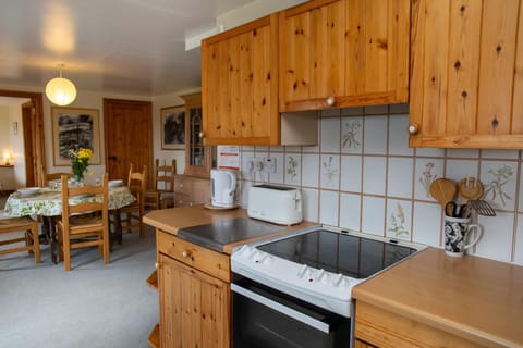 Kitchen with electric cooker, kettle and toaster with view of dining area