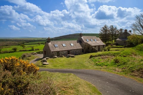 View of Cnwc y Bran cottage, the entrance track and surrounding countryside