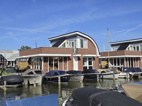 Water, Sky, Cloud, Boat, Building, Watercraft, Body Of Water, House, Lake, Vehicle