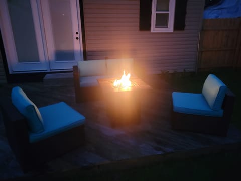 Cozy up around the backyard fire-table at night.