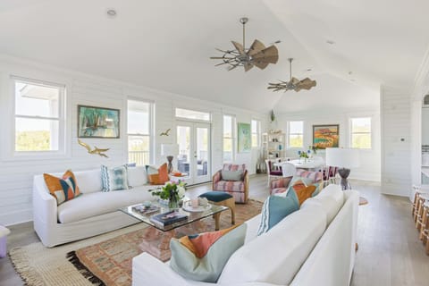 Expansive living room with a lot of seating and open to both dining and kitchen.