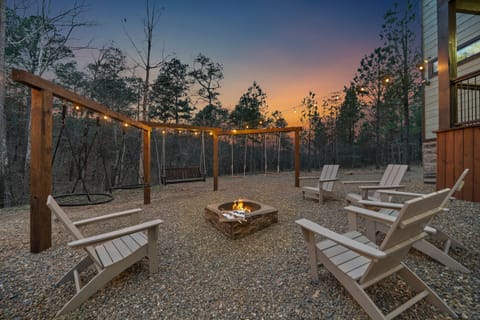 At ground level, discover a set of saucer swings, a bench swing, a set of regular swings, and the firepit.