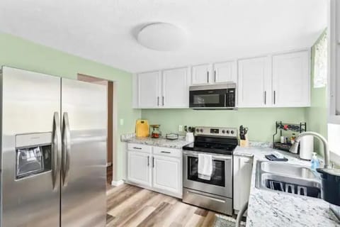 Well equipped kitchen with a large fridge.