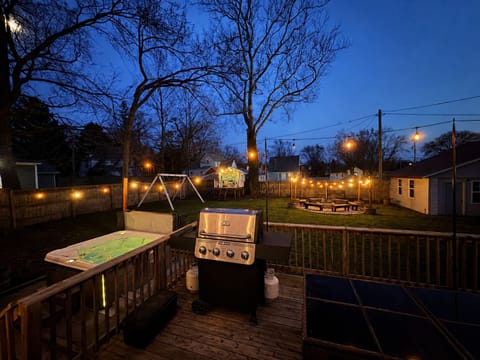 The spacious backyard- complete with a hot tub, deck with a gas grill, bon fire area, swing set, kid's playhouse, hammocks, and yard games!