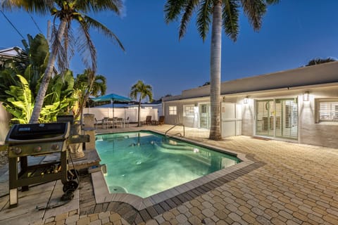 Twilight reflections on the heated pool while the patio invites lazy evenings.