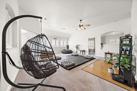 Yoga/meditation room with hanging chair, mats, and bean bag chair to relax during your trip