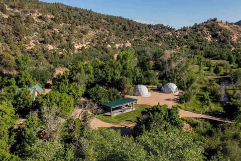 Ariel view of Zen Zion featuring River Dome and Evergreen Dome (you can also see the rooftops of Honeybee and Hummingbird cabins as well as the shared pavilion)