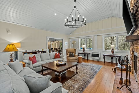 Living Room with wood burning fireplace and TV
