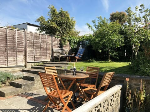 Garden with small garden table and chairs, bench