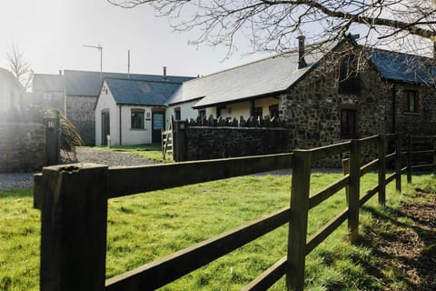 Outside Toes Rock Cottage, grass area and fence leading to entrance