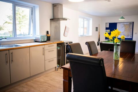 Kitchen/diner with table and chairs and games area with pool table