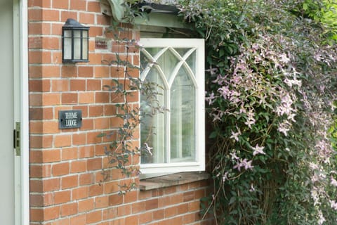 Thyme Lodge with clematis around the window