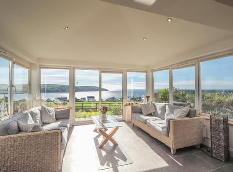 Conservatory area, sofas, coffee table, sea views