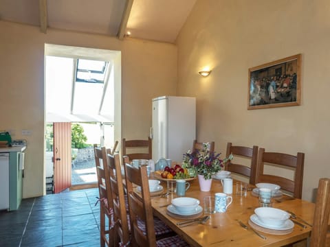 Dining area with table and chairs and fridge/freezer