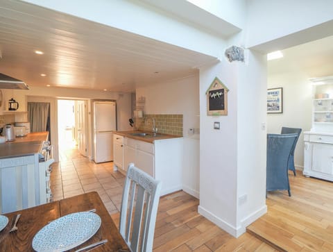 Kitchen with dining table and chairs in the foreground