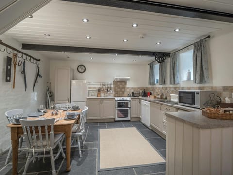 Kitchen/diner: table with four chairs, cooker, microwave, fridge/freezer, dishwasher, kettle and toaster