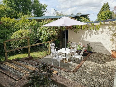 Outside table and four chairs with parasol in the garden