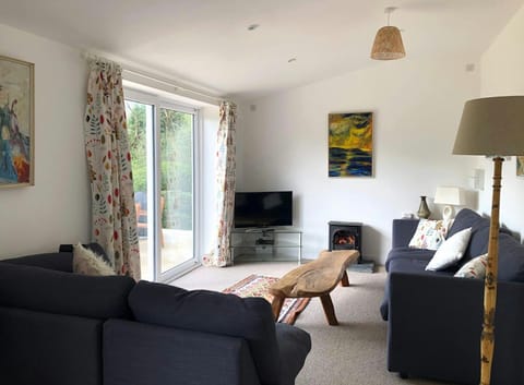 living room with coffee table and TV. Woodburner