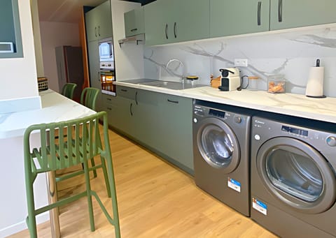 Design Townhome | Private kitchen | Full-size fridge, microwave, oven, stovetop