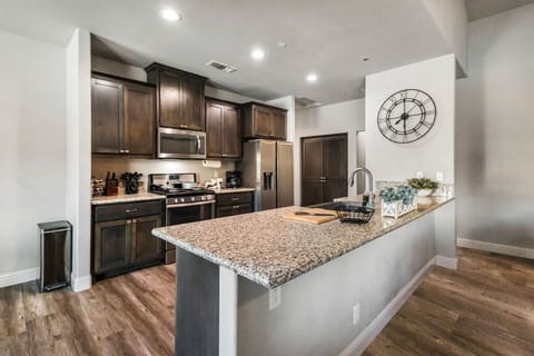 Large granite island and modern appliances make meal prep a social experience.