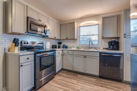 The full kitchen has refrigerator, stove, microwave, and dishwasher.