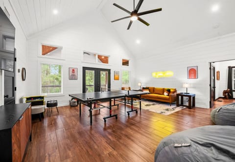 A room filled with games and comfortable seating, making it ideal for gatherings and fun.