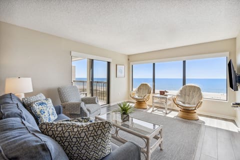 Enjoy Breathtaking Views on Three Sides in this Stunning Living Area with Two Private Balconies and a Flat Screen TV