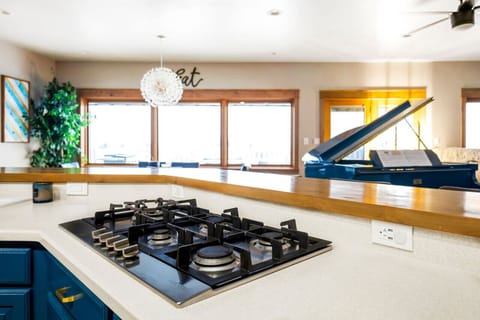 Designer Kitchen Remodel by Wrecked & Refined - Modern Lighting & Backsplash with City Views