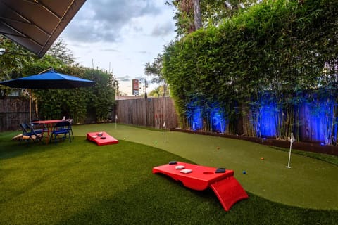 Ultimate game day vibes with mini golf and cornhole, plus a shaded lounge in a fully fenced yard