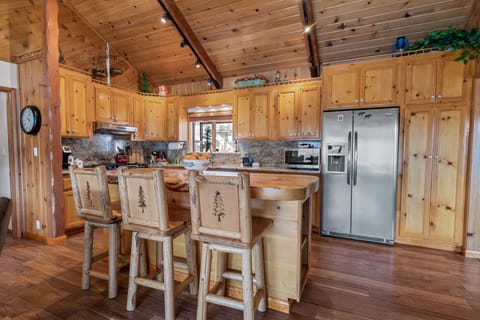 Kitchen - The kitchen is fully equipped w/granite countertops, stainless steel appliances, & a custom wood-top island w/seating.