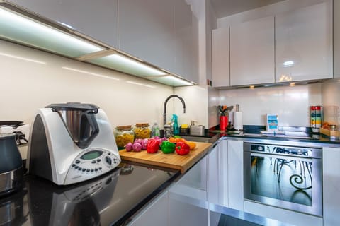 Modern fully equipped kitchen with a spacious countertop, perfect for preparing meals with else.