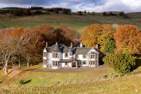 Scottish mansion in Angus, Kinclune House, surrounded by autumn beech trees 