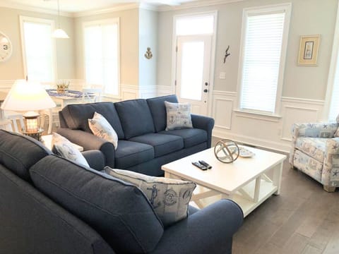 Coastal living room with nautical decor and plush seating