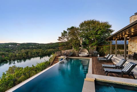 The pool area, with its chic design and tranquil lake view, invites you to relax in style.