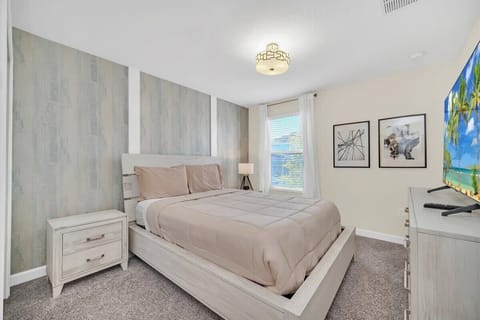 Enjoy a little extra relaxation in this spacious king bedroom featuring comfortable bedding, tasteful décor, a flat-screen TV, and high-speed Wi-Fi—your own peaceful retreat during your vacation.