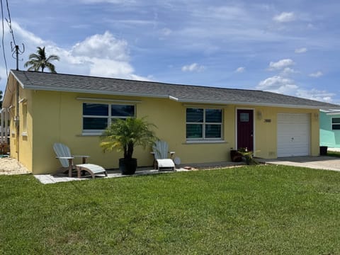 Front of home with plenty of parking for boat trailer in yard and cars in driveway