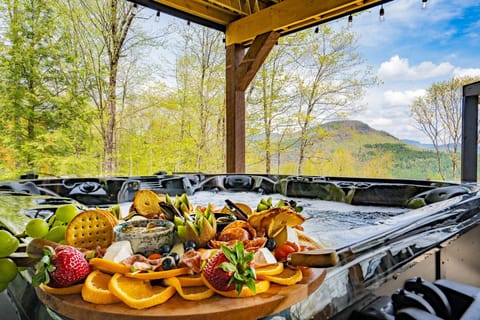 Enjoy a peaceful soak in our hot tub with stunning views of the mountains. Embrace the tranquility of the view and let your stresses melt away as you relax in style and comfort.