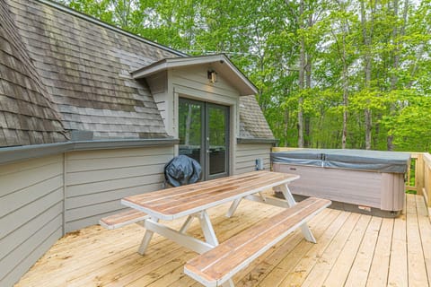 The back deck has a large picnic table and BBQ grill