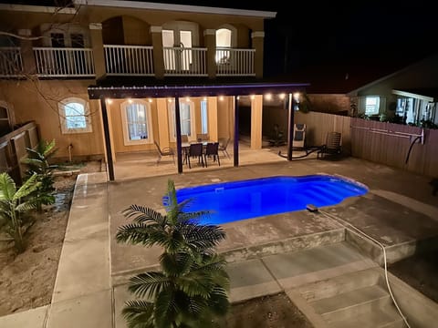 Backyard with outdoor table with seating for 6 and private pool