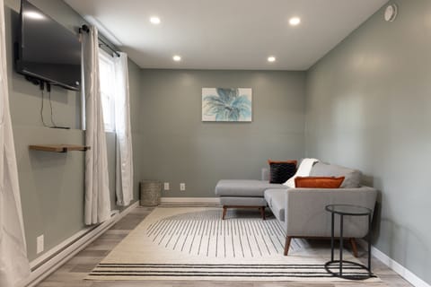 Spacious Living room with couch and Smart TV.