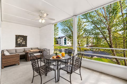 The screened patio offers a view of the resort pool and the golf course.