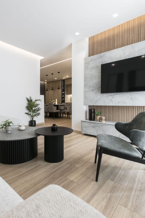 Luxury Apartment, 3 Bedrooms, Air conditioning | Living area | 50-inch flat-screen TV with cable channels