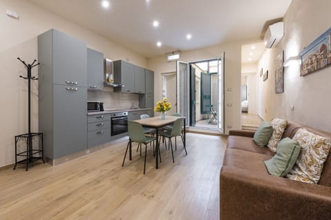Deluxe Apartment | Living area | 40-inch flat-screen TV with digital channels