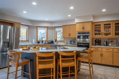 The kitchen features sleek stainless steel appliances and is fully stocked with everything you need for cooking.
