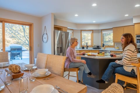 Enjoy a glass of wine at the bar counter—cheers to a relaxing stay!