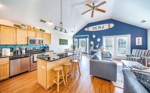 Sunny open-concept kitchen and living area with island seating for three