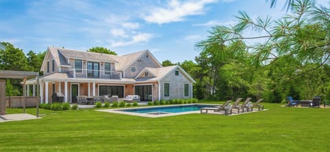 Backyard with heated salt water pool/spa, firepit, outdoor shower and deck.