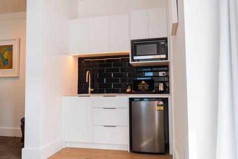 Waterfront Apartment | Private kitchen | Fridge, electric kettle